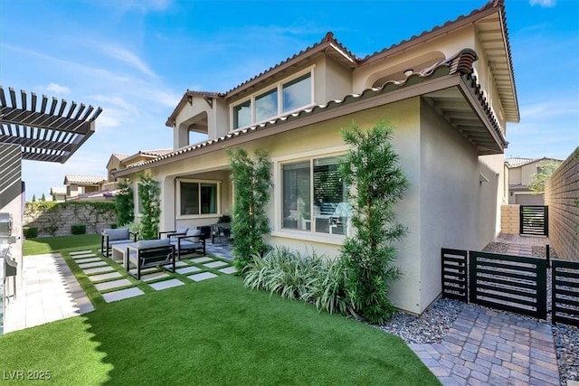 rear view of house featuring stucco siding, a yard, outdoor lounge area, and a patio