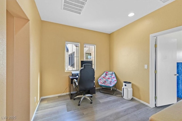 office space featuring light wood-style floors, visible vents, and baseboards