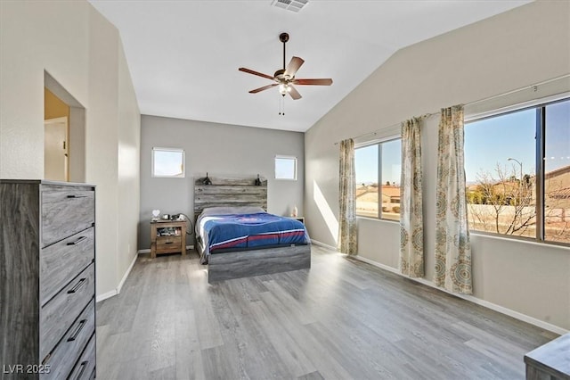 bedroom featuring vaulted ceiling, wood finished floors, a ceiling fan, and baseboards