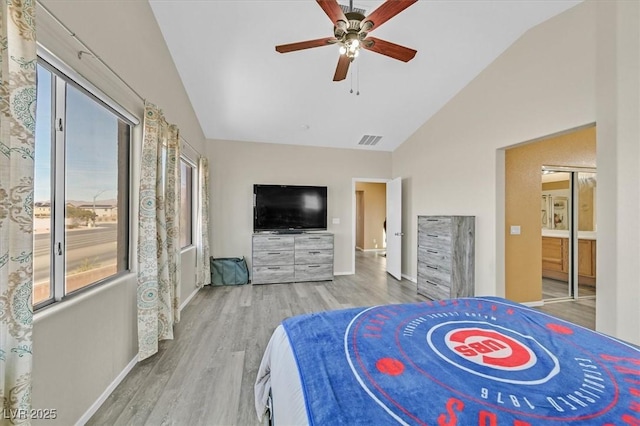 bedroom with light wood-type flooring, lofted ceiling, visible vents, and baseboards