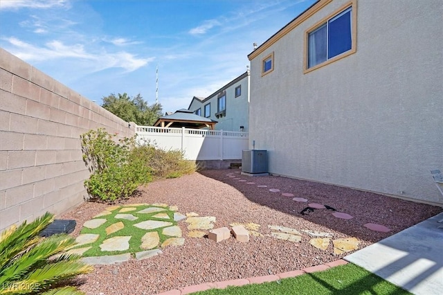 view of yard featuring cooling unit and a fenced backyard