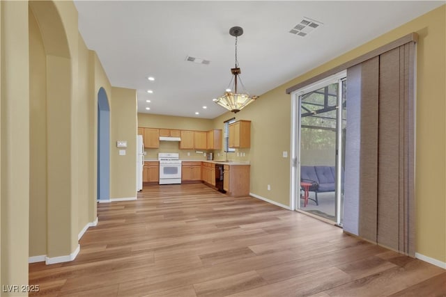 kitchen with light wood-style flooring, stove, light countertops, dishwasher, and decorative light fixtures