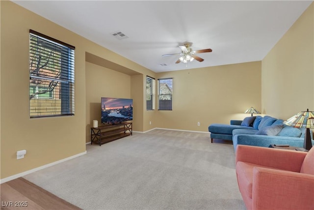 living room with a wealth of natural light, visible vents, and baseboards