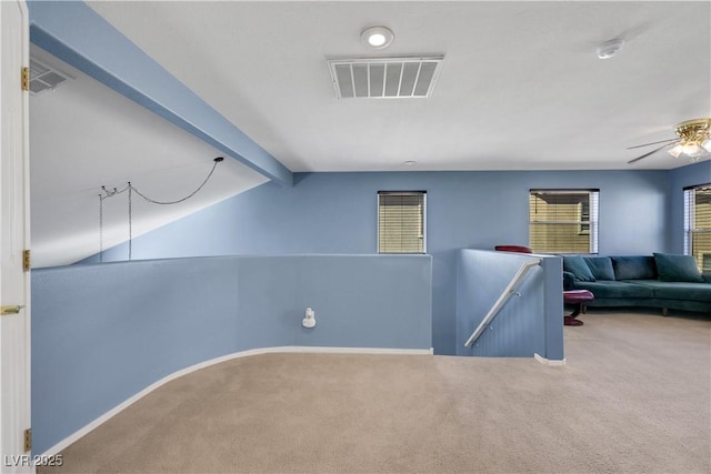 interior space with vaulted ceiling with beams, baseboards, and visible vents