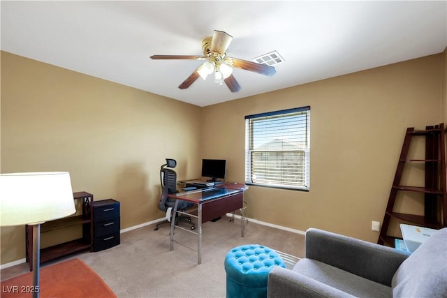 office featuring light colored carpet, visible vents, ceiling fan, and baseboards