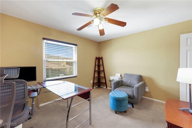 office featuring baseboards, a ceiling fan, and light colored carpet