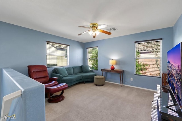 living area with a ceiling fan, visible vents, light carpet, and baseboards