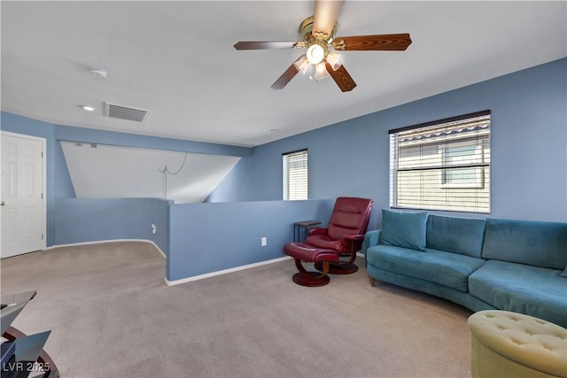 carpeted living area with baseboards, visible vents, and a ceiling fan