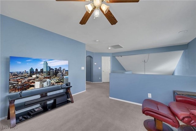 living area with arched walkways, carpet, visible vents, a ceiling fan, and baseboards