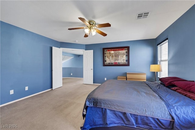 bedroom featuring a ceiling fan, light colored carpet, visible vents, and baseboards