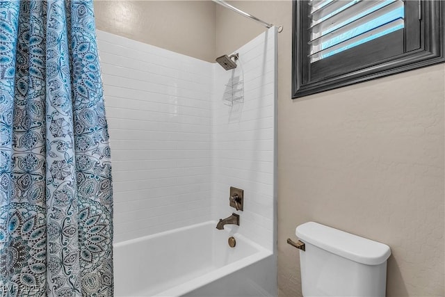 bathroom with shower / tub combo and toilet