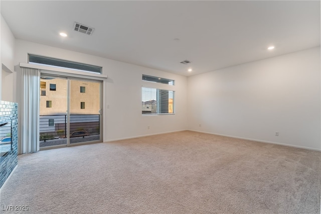 unfurnished room with recessed lighting, visible vents, baseboards, and light colored carpet