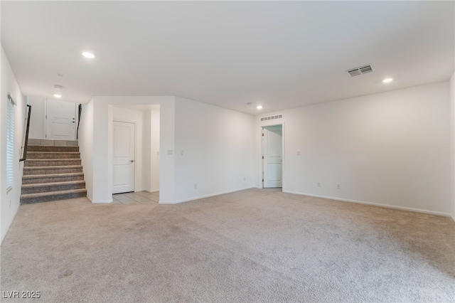 spare room featuring recessed lighting, light colored carpet, visible vents, and stairs