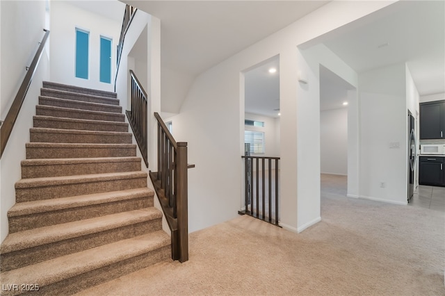 stairs with carpet floors, baseboards, and recessed lighting