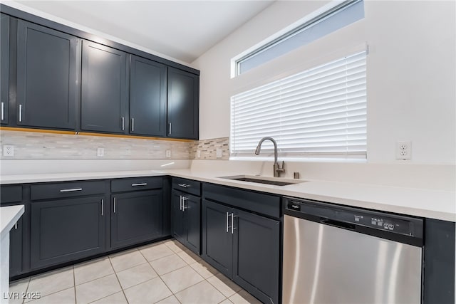 kitchen with decorative backsplash, light countertops, dishwasher, and a sink