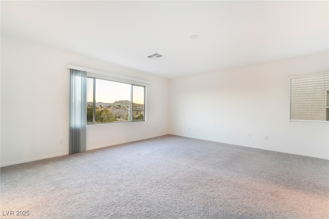 carpeted spare room with visible vents