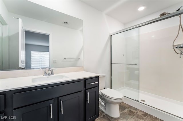 full bath featuring toilet, a stall shower, visible vents, and vanity