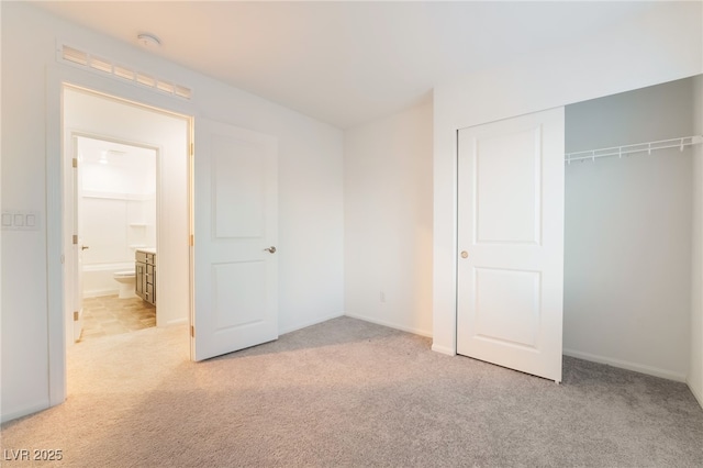 unfurnished bedroom featuring a closet and light colored carpet