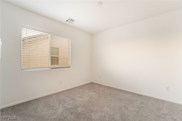 empty room with baseboards, visible vents, and carpet flooring