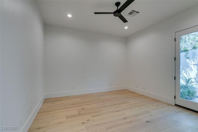 unfurnished room featuring light wood-style floors, ceiling fan, visible vents, and baseboards