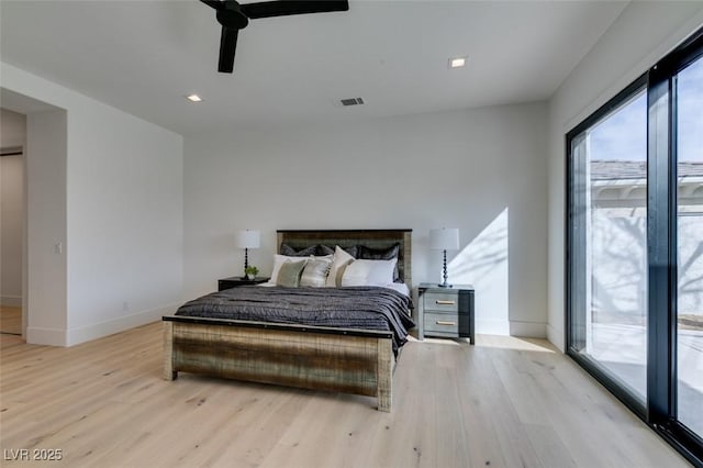 bedroom featuring visible vents, ceiling fan, light wood-style flooring, and baseboards