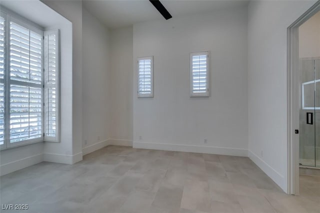 unfurnished room featuring baseboards, ceiling fan, and a healthy amount of sunlight