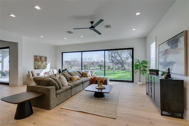 living area featuring light wood finished floors, visible vents, and recessed lighting