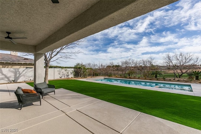 view of patio with a fenced backyard, a fenced in pool, and a ceiling fan