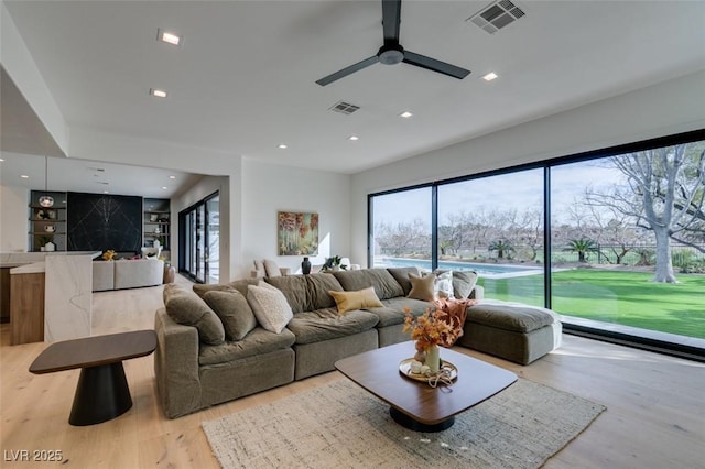 living area featuring light wood-style floors, visible vents, and recessed lighting