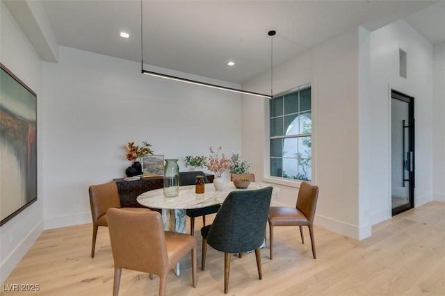 dining space with baseboards, recessed lighting, and light wood-style floors