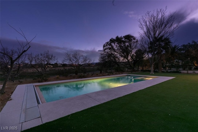 outdoor pool with a patio area and a lawn