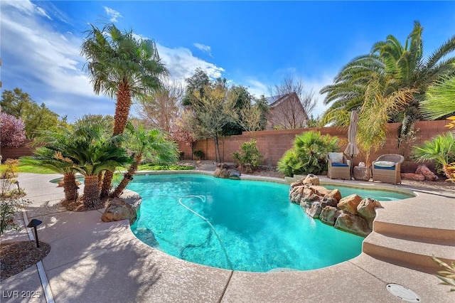 view of swimming pool with a fenced backyard and a fenced in pool