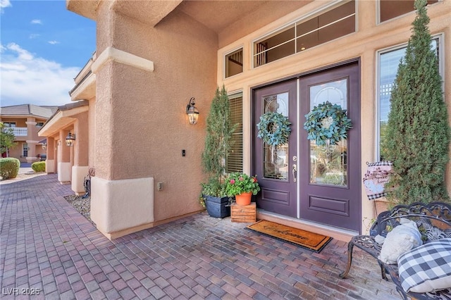 entrance to property with french doors and stucco siding