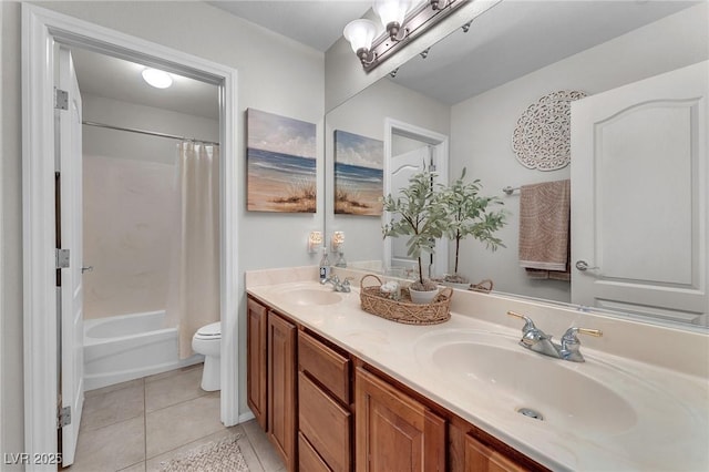 full bathroom featuring double vanity, a sink, toilet, and tile patterned floors