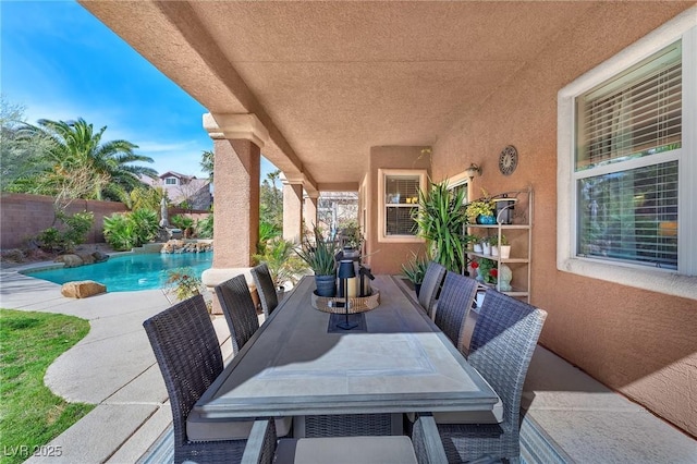 view of patio / terrace with outdoor dining area, a fenced backyard, and a fenced in pool