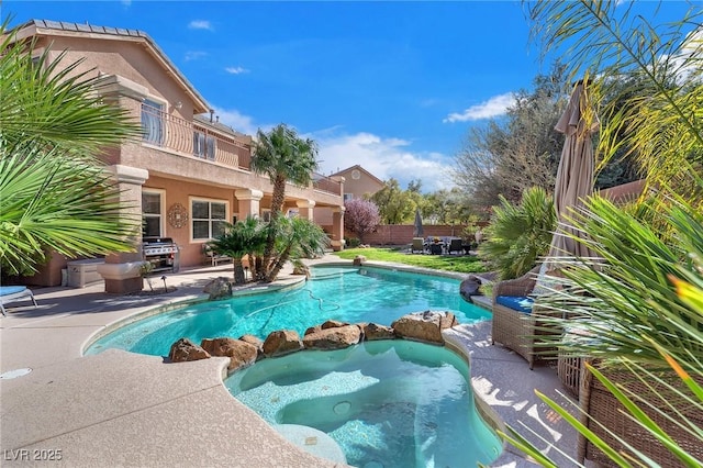 view of swimming pool featuring a pool with connected hot tub, a patio area, fence, and area for grilling