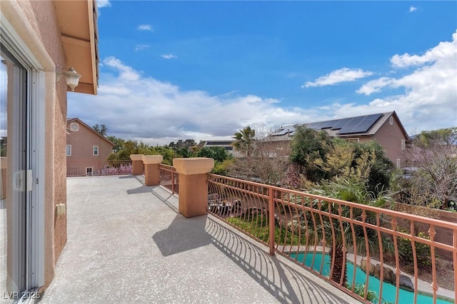 view of patio / terrace with a fenced in pool and a balcony