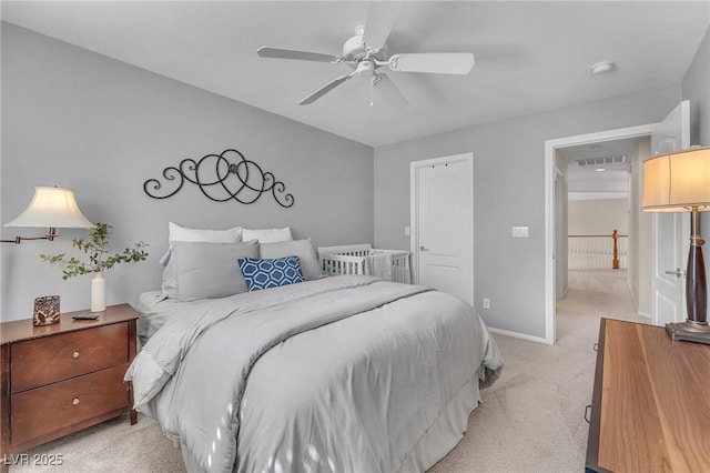 bedroom featuring a ceiling fan, light carpet, visible vents, and baseboards