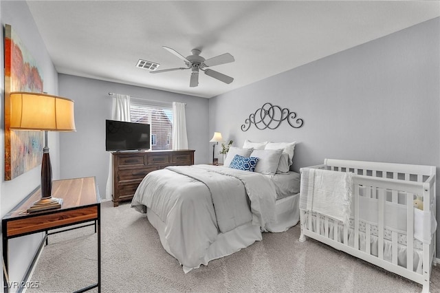 bedroom with carpet floors, visible vents, and a ceiling fan