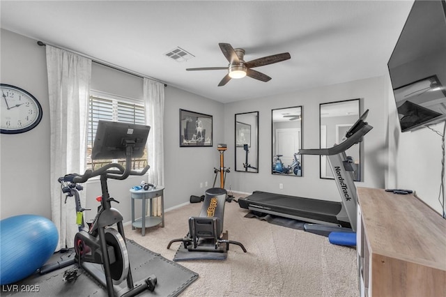 exercise room with baseboards, visible vents, ceiling fan, and carpet flooring