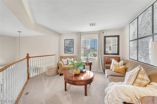 living area with carpet flooring and visible vents