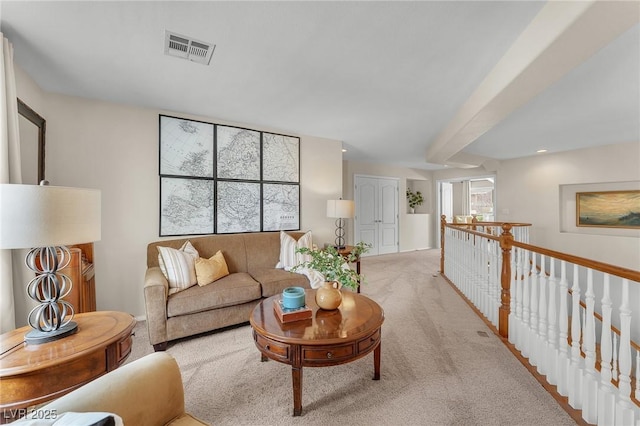 living area featuring visible vents and light colored carpet