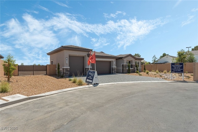 6312 Zephyr Ct, Las Vegas, NV 89149 - view of front facade with a gate, a garage, stone siding, decorative driveway, and stucco siding