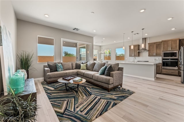6312 Zephyr Ct, Las Vegas, NV 89149 - living room featuring light wood-style flooring, recessed lighting, and baseboards