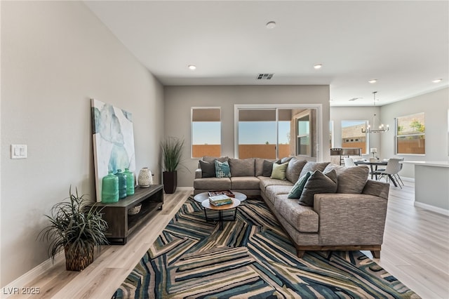 6312 Zephyr Ct, Las Vegas, NV 89149 - living room featuring a chandelier, wood finished floors, baseboards, and recessed lighting