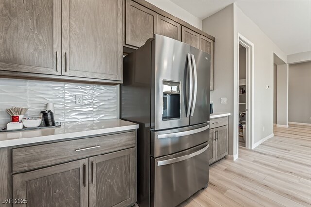 6312 Zephyr Ct, Las Vegas, NV 89149 - kitchen with stainless steel fridge, light wood-style floors, light countertops, and baseboards