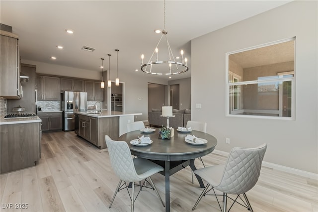 6312 Zephyr Ct, Las Vegas, NV 89149 - dining space featuring light wood-style floors, a chandelier, baseboards, and recessed lighting