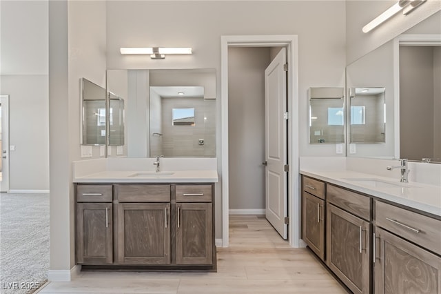 6312 Zephyr Ct, Las Vegas, NV 89149 - full bathroom with two vanities, baseboards, and wood finished floors