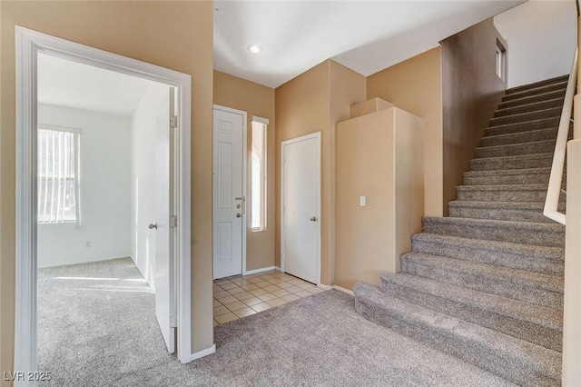 interior space with carpet floors and tile patterned flooring