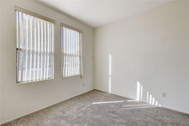 spare room with carpet and baseboards